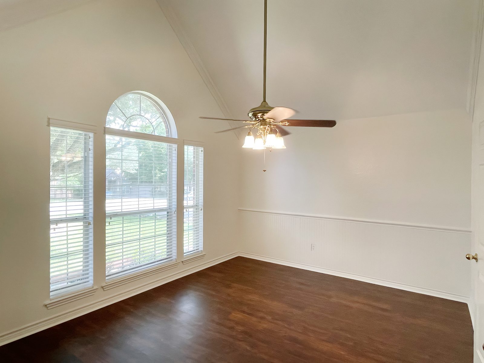 The same dining room after, white with wainscoting