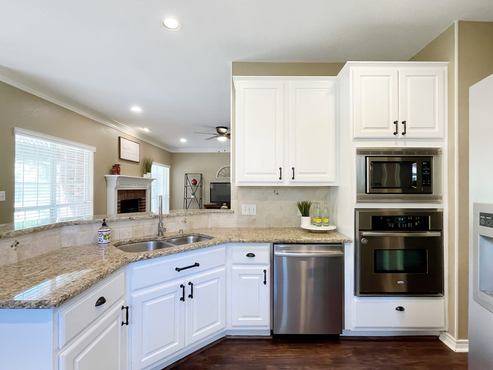 The same corner after, cabinets painted white with black hardware