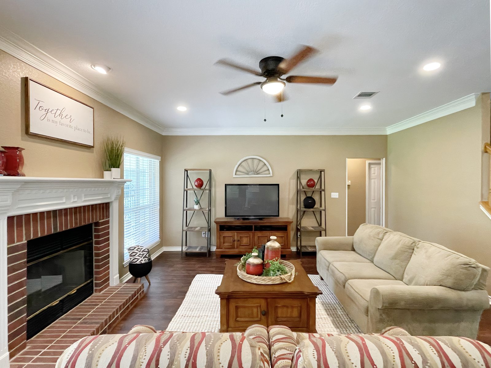 Living room with brick fireplace and white mantel