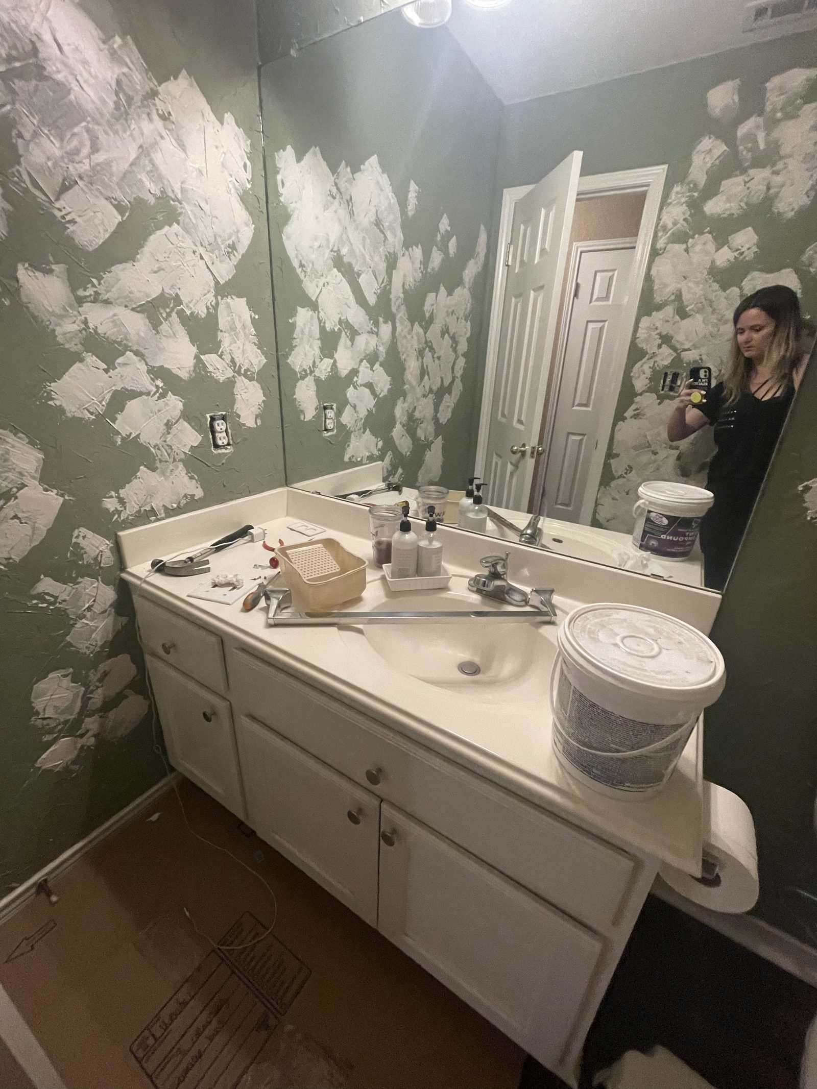 Bathroom walls covered in patch compound before sanding