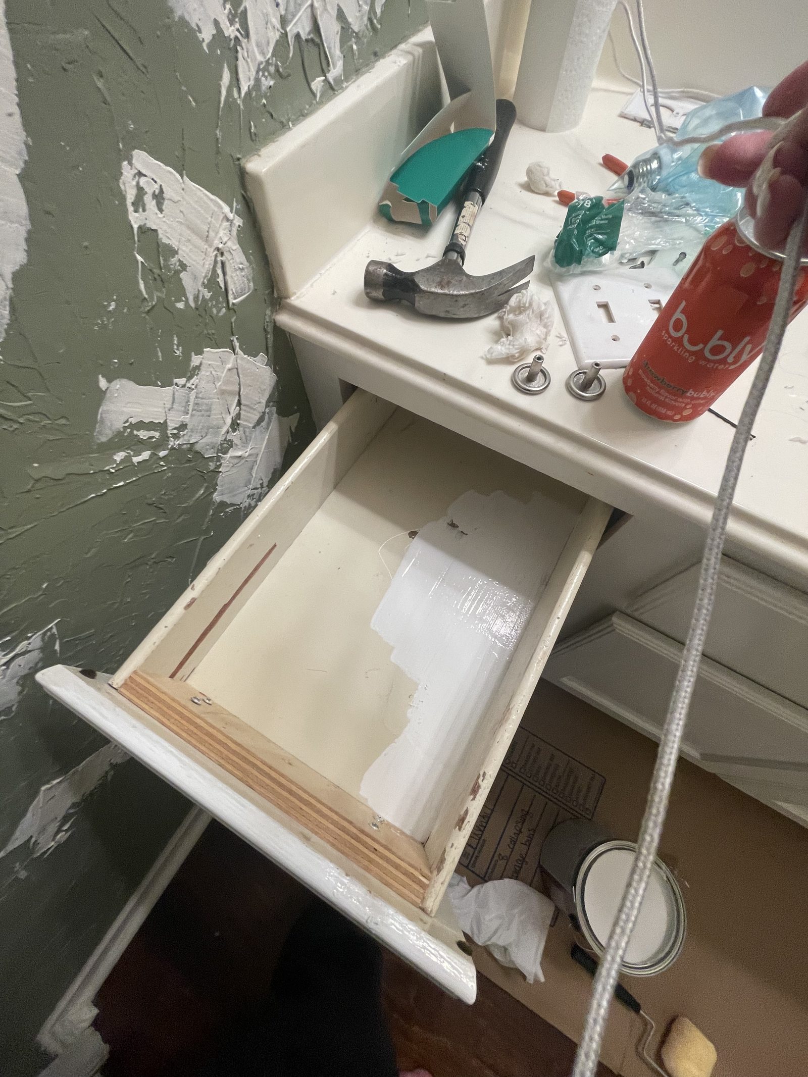 Work table with tools, brushes and paint supplies