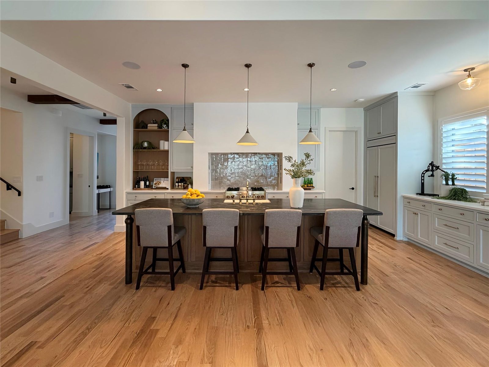 Kitchen island with soapstone counter and pendant lighting